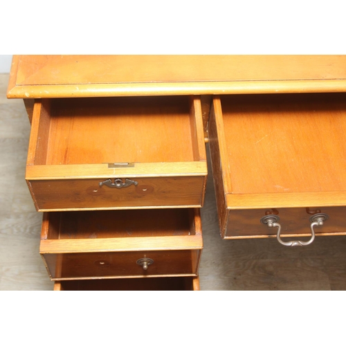 107 - A vintage Yew wood pedestal desk with inset green leather top, 120cm x 61cm x 77cm