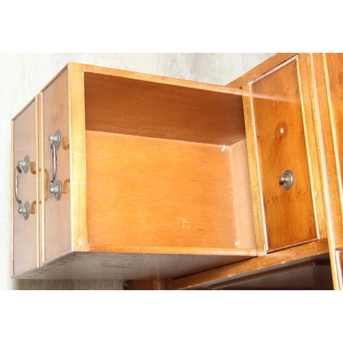 107 - A vintage Yew wood pedestal desk with inset green leather top, 120cm x 61cm x 77cm