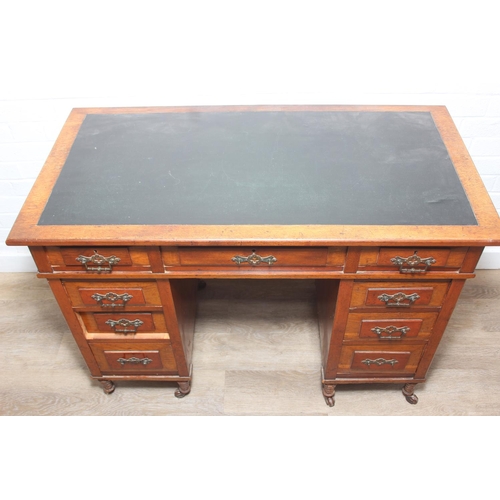 59 - An Edwardian three part desk with inset dark leather top and castors, brass fittings, 106cm x 55cm x... 