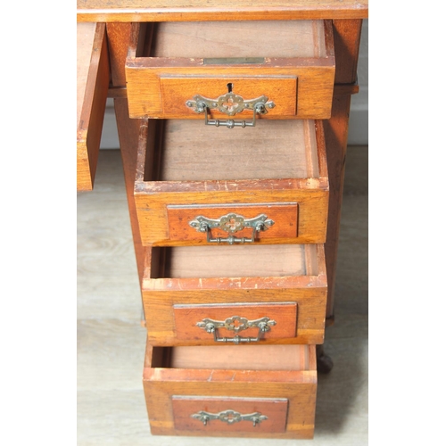 59 - An Edwardian three part desk with inset dark leather top and castors, brass fittings, 106cm x 55cm x... 