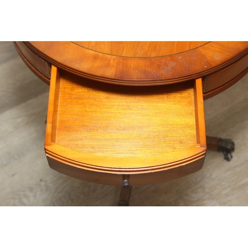 97 - An antique style drum table with round splayed legs, 49cm in diameter x 58cm tall