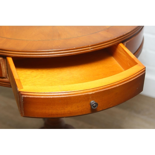 97 - An antique style drum table with round splayed legs, 49cm in diameter x 58cm tall