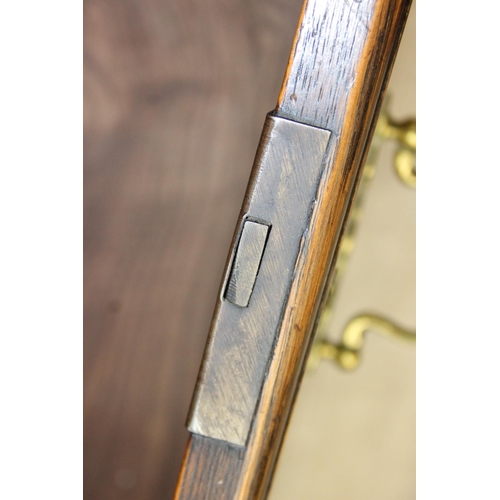 62 - A Georgian style oak sideboard with three deep drawers and brass curtained rail, early 20th century,... 