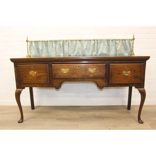 62 - A Georgian style oak sideboard with three deep drawers and brass curtained rail, early 20th century,... 