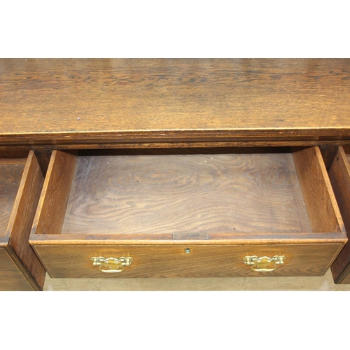 62 - A Georgian style oak sideboard with three deep drawers and brass curtained rail, early 20th century,... 