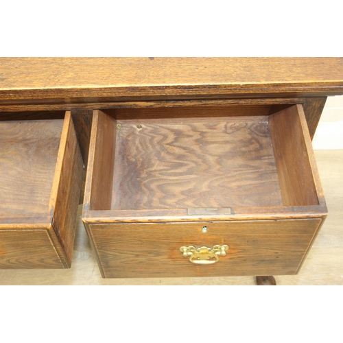 62 - A Georgian style oak sideboard with three deep drawers and brass curtained rail, early 20th century,... 