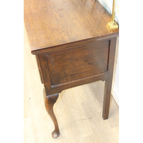 62 - A Georgian style oak sideboard with three deep drawers and brass curtained rail, early 20th century,... 