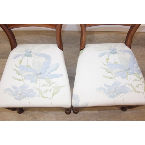 81 - A pair of Victorian mahogany side or bedroom chairs with later floral upholstery, each 82cm tall and... 