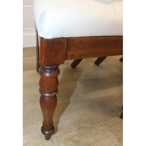 81 - A pair of Victorian mahogany side or bedroom chairs with later floral upholstery, each 82cm tall and... 