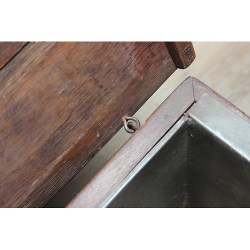 108 - An antique oak cellarette or coal bucket with metal lining, seemingly made from parts of an 18th cen... 