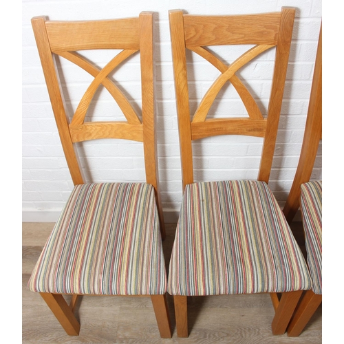 37 - Set of six modern oak dining chairs with arched X form design to back and multi-coloured fabric upho... 