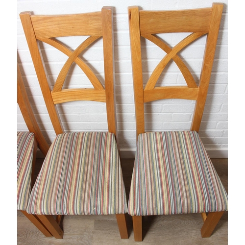 37 - Set of six modern oak dining chairs with arched X form design to back and multi-coloured fabric upho... 