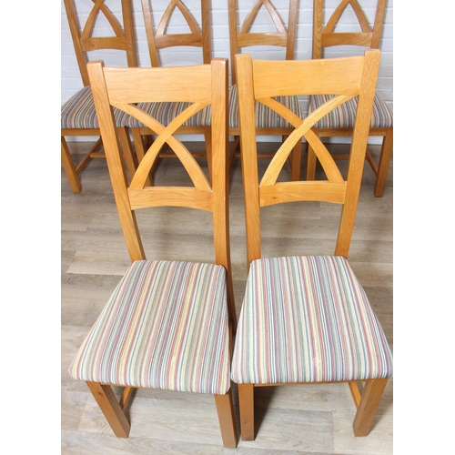37 - Set of six modern oak dining chairs with arched X form design to back and multi-coloured fabric upho... 