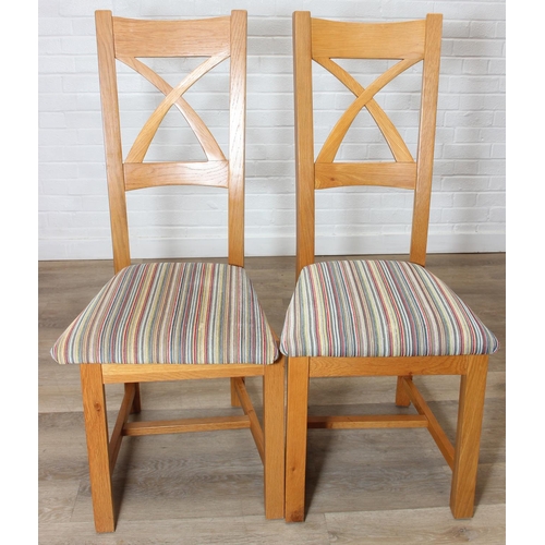 37 - Set of six modern oak dining chairs with arched X form design to back and multi-coloured fabric upho... 