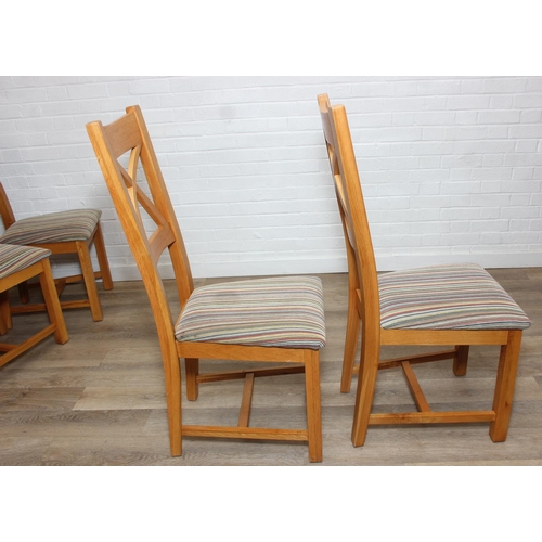 37 - Set of six modern oak dining chairs with arched X form design to back and multi-coloured fabric upho... 