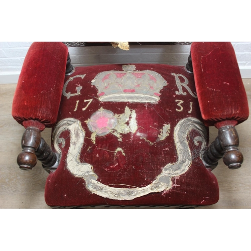 38 - An unusual antique carved oak throne chair with 1731 King George II related embroidery, the chair be... 