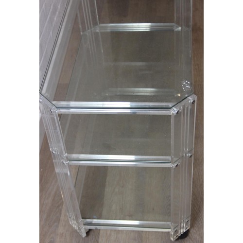 18 - A retro clear Perspex, Acrylic or Lucite serving trolley, three tiers with wheels, likely c.1980's, ... 
