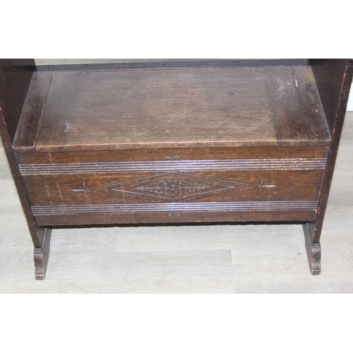 61 - A vintage oak metamorphic monk's bench with carved detail to front panel, the bench has a hinged sea... 