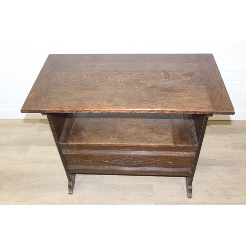 61 - A vintage oak metamorphic monk's bench with carved detail to front panel, the bench has a hinged sea... 