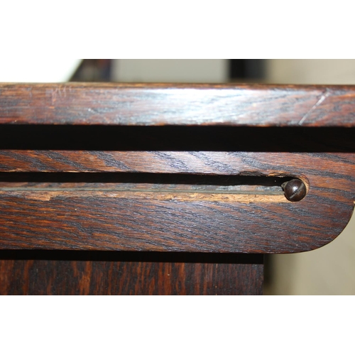 61 - A vintage oak metamorphic monk's bench with carved detail to front panel, the bench has a hinged sea... 