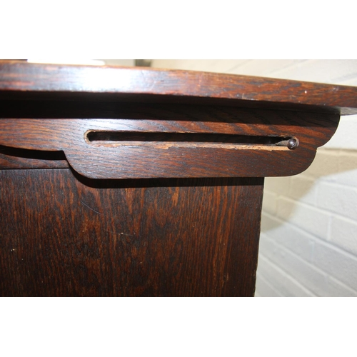 61 - A vintage oak metamorphic monk's bench with carved detail to front panel, the bench has a hinged sea... 