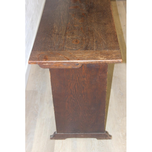 61 - A vintage oak metamorphic monk's bench with carved detail to front panel, the bench has a hinged sea... 