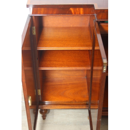 20 - William Tillman Furniture - a Regency style flame Mahogany sideboard, four doors with the central pa... 