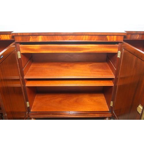 20 - William Tillman Furniture - a Regency style flame Mahogany sideboard, four doors with the central pa... 