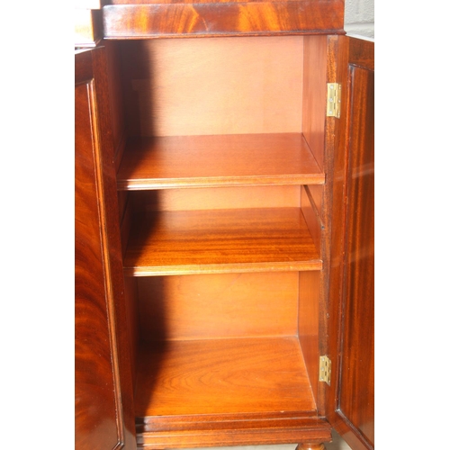 20 - William Tillman Furniture - a Regency style flame Mahogany sideboard, four doors with the central pa... 