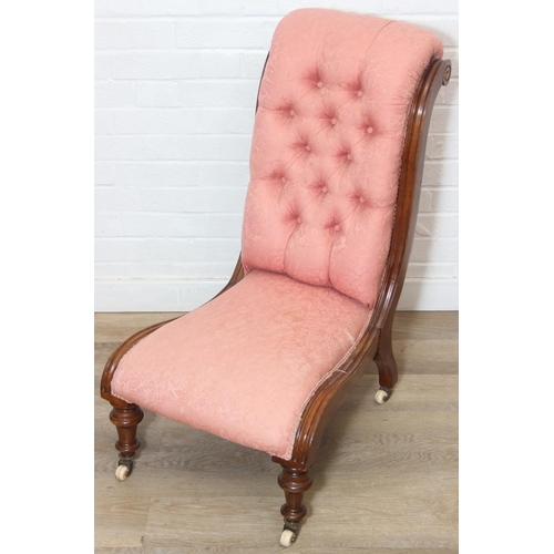 118 - A Victorian period nursing chair with pink button back upholstery, exposed mahogany frame and brass ... 