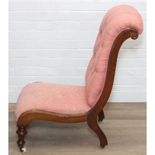 118 - A Victorian period nursing chair with pink button back upholstery, exposed mahogany frame and brass ... 