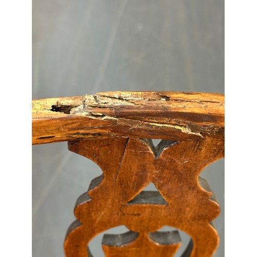 109 - An antique elm seated Thames Valley or Windsor farmhouse armchair with stick back and decorative spl... 