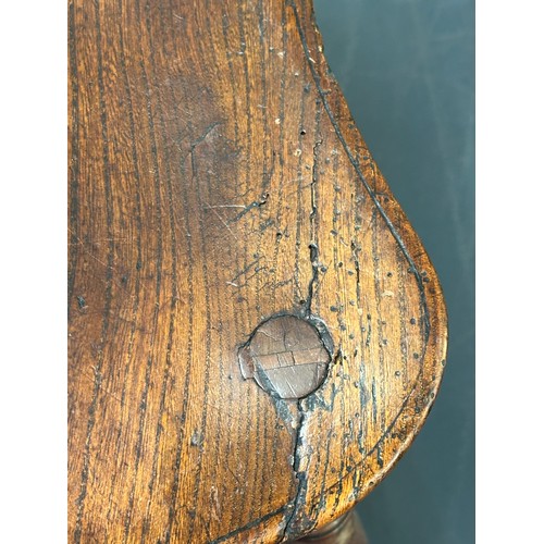 109 - An antique elm seated Thames Valley or Windsor farmhouse armchair with stick back and decorative spl... 