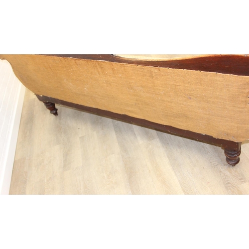 68 - A Victorian roll end sofa or settee with exposed mahogany frame, buff upholstery, 224cm long x 94cm ...