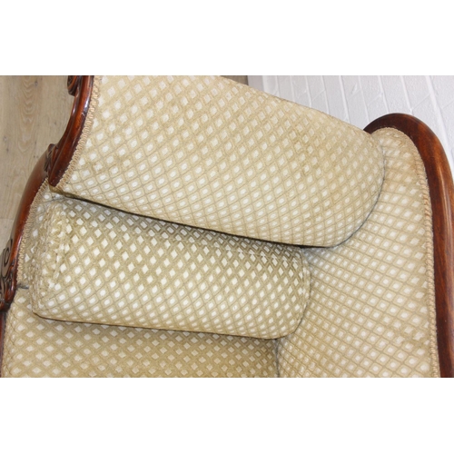 68 - A Victorian roll end sofa or settee with exposed mahogany frame, buff upholstery, 224cm long x 94cm ...