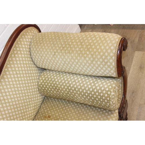 68 - A Victorian roll end sofa or settee with exposed mahogany frame, buff upholstery, 224cm long x 94cm ...