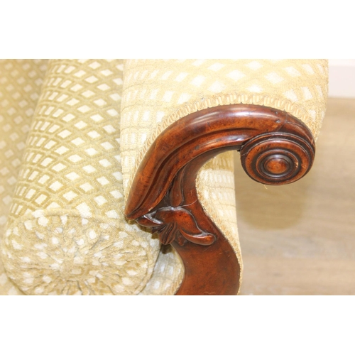 68 - A Victorian roll end sofa or settee with exposed mahogany frame, buff upholstery, 224cm long x 94cm ...
