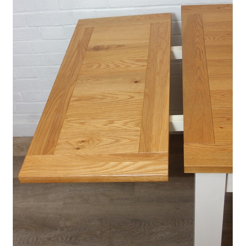 76 - Modern white painted extending dining table with oak top and four matching chairs, the table 68cm x ...