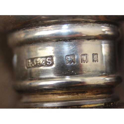 1006 - A leather cased gentleman's travelling vanity set, harlequin pieces but to include four silver toppe... 