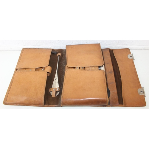 1006 - A leather cased gentleman's travelling vanity set, harlequin pieces but to include four silver toppe... 