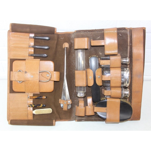 1006 - A leather cased gentleman's travelling vanity set, harlequin pieces but to include four silver toppe... 