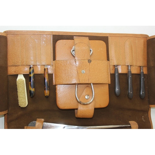 1006 - A leather cased gentleman's travelling vanity set, harlequin pieces but to include four silver toppe... 