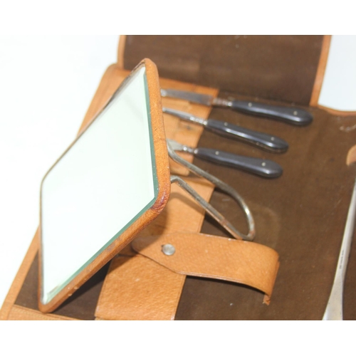 1006 - A leather cased gentleman's travelling vanity set, harlequin pieces but to include four silver toppe... 