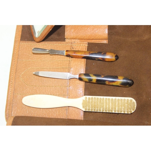 1006 - A leather cased gentleman's travelling vanity set, harlequin pieces but to include four silver toppe... 