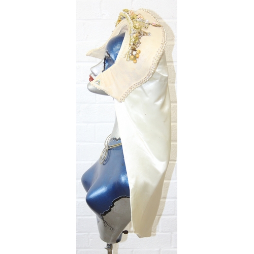 239D - An Art Deco style painted mannequin on adjustable stand, with head dress