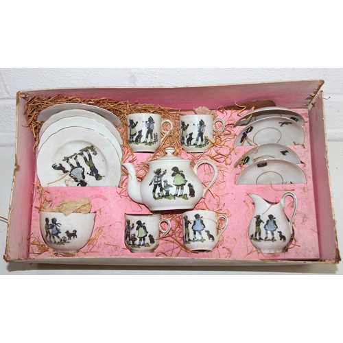 612 - A vintage boxed child's or dolls tea set decorated with scenes of children, with original straw fill... 
