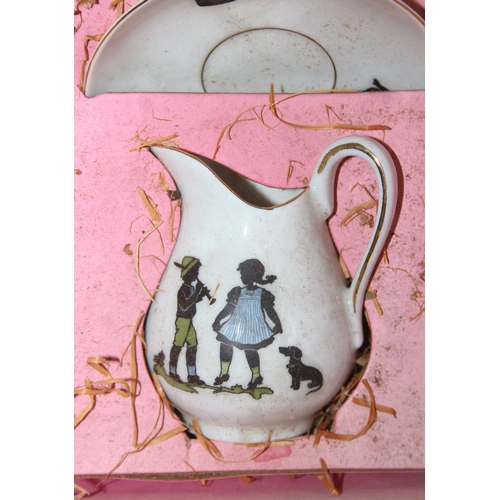 612 - A vintage boxed child's or dolls tea set decorated with scenes of children, with original straw fill... 