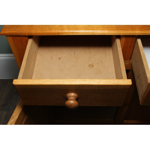 14 - A modern light oak three drawer two door sideboard made by Neil Thompson, 156cm x 55cm x 101cm