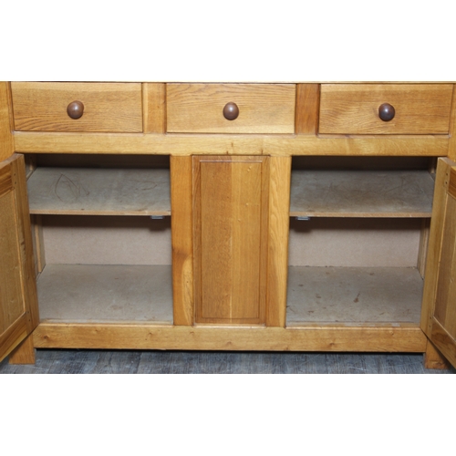 14 - A modern light oak three drawer two door sideboard made by Neil Thompson, 156cm x 55cm x 101cm