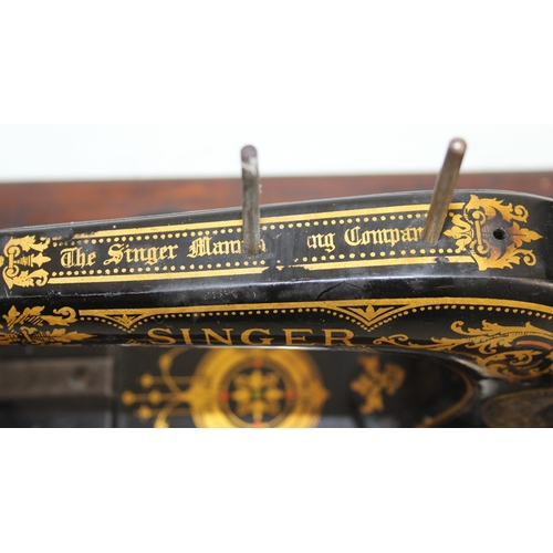 A Victorian cast iron Singer sewing machine with decorative gold ...